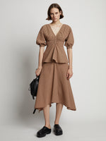 Front image of model wearing Gingham Long Sleeve Peplum Top in coral/black