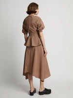 Back image of model wearing Gingham Long Sleeve Peplum Top in coral/black