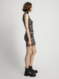 Side image of model wearing Printed Smocked Mini Dress in mint/black