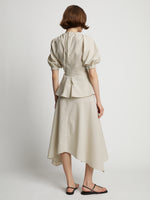 Back image of model wearing Gingham Long Sleeve Peplum Top in buttercream/fawn