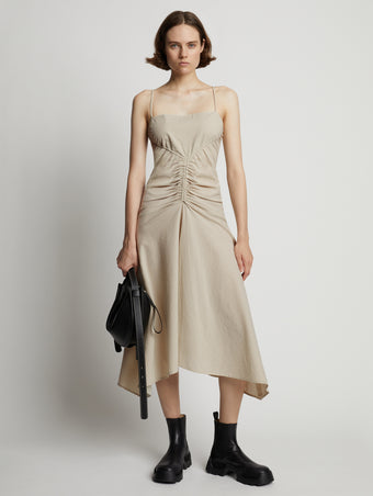 Front image of model wearing Gingham Ruched Strappy Dress in buttercream/fawn