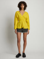 Front image of model wearing Poplin V-Neck Top in sun