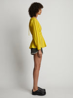 Side image of model wearing Poplin V-Neck Top in sun
