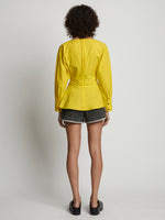 Back image of model wearing Poplin V-Neck Top in sun