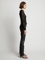 Side image of model wearing Sheer Stripe Sweater in black/red