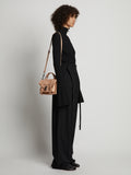 Image of model carrying Topstitch PS1 Tiny Bag in LIGHT NUDE