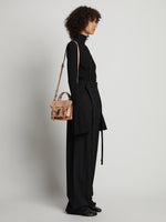 Image of model carrying Topstitch PS1 Tiny Bag in LIGHT NUDE