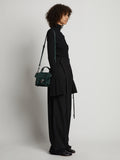 Image of model carrying Topstitch PS1 Tiny Bag in DARK GREEN