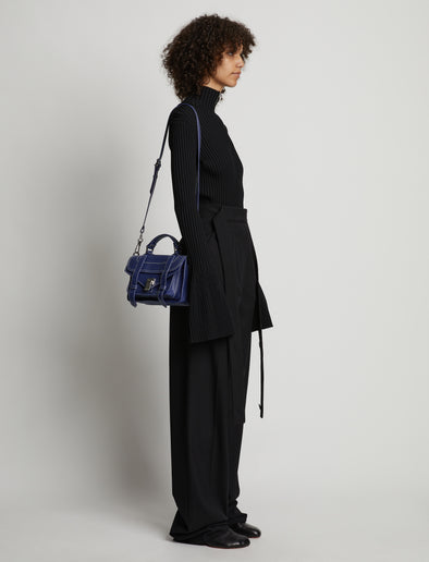 Image of model carrying Topstitch PS1 Tiny Bag in NEW BLUE