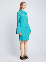 Side image of model wearing Stretch Lace Shirt Dress in cyan