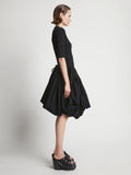 Side image of model wearing Technical Nylon Skirt in black