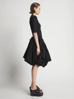 Side image of model wearing Technical Nylon Skirt in black