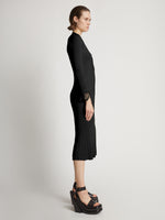 Side image of model wearing Viscose Knit Dress in black