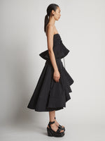 Side image of model wearing Technical Nylon Strapless Top in black