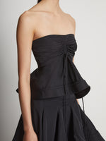 Detail image of model wearing Technical Nylon Strapless Top in black