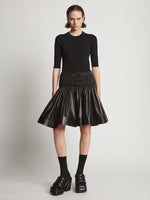 Front image of model wearing Nappa Skirt in black