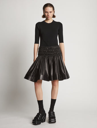 Front image of model wearing Nappa Skirt in black