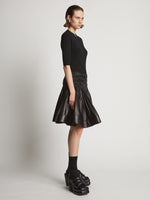 Side image of model wearing Nappa Skirt in black