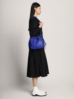 Image of model wearing Drawstring Pouch in COBALT