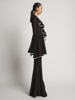 Side image of model wearing Solid Mesh Ruffle Shirt in black