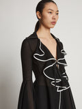 Detail image of model wearing Solid Mesh Ruffle Shirt in black