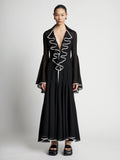 Front image of model wearing Solid Mesh Ruffle Dress in black