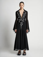 Front image of model wearing Solid Mesh Ruffle Dress in black