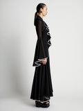 Side image of model wearing Solid Mesh Ruffle Dress in black