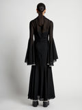 Back image of model wearing Solid Mesh Ruffle Dress in black