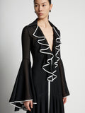 Detail image of model wearing Solid Mesh Ruffle Dress in black