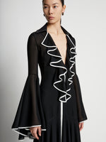 Detail image of model wearing Solid Mesh Ruffle Dress in black