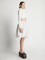Side image of model wearing Technical Nylon Skirt in off white