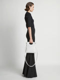 Image of model carrying Small Bar Bag in OPTIC WHITE