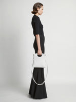 Image of model carrying Small Bar Bag in OPTIC WHITE