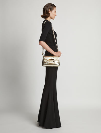 Image of model carrying Metallic Small Bar Bag in LIGHT GOLD