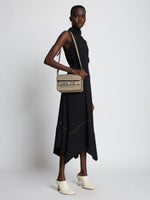 Image of model wearing PS11 Mini Classic Bag in light taupe