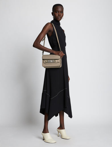Image of model wearing PS11 Mini Classic Bag in light taupe