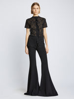 Front image of model wearing Stretch Lace Top in black