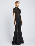 Side image of model wearing Stretch Lace Top in black