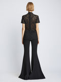 Back image of model wearing Stretch Lace Top in black
