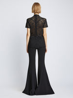 Back image of model wearing Stretch Lace Top in black