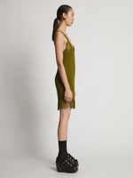 Side image of model wearing Embroidered Viscose Knit Dress in olive