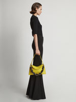 Image of model carrying Contrast Rolo Strap Braid Bag in CANARY YELLOW