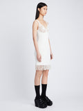 Side image of model wearing Embroidered Viscose Knit Dress in off white