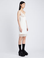Side image of model wearing Embroidered Viscose Knit Dress in off white