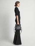 Image of model carrying Small Bar Bag in BLACK