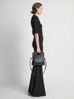 Image of model carrying Small Bar Bag in BLACK