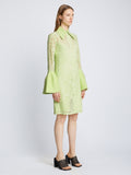 Side image of model wearing Stretch Lace Shirt Dress in lime