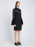 Side image of model wearing Stretch Lace Shirt Dress in black