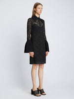 Side image of model wearing Stretch Lace Shirt Dress in black